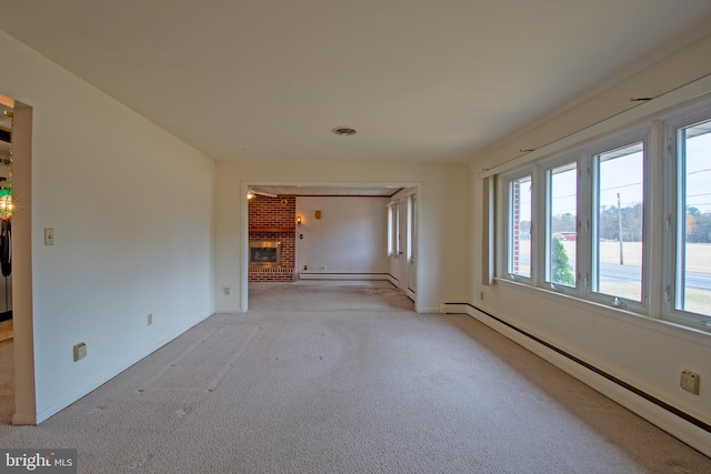 unfurnished room with a brick fireplace, light colored carpet, and a baseboard radiator