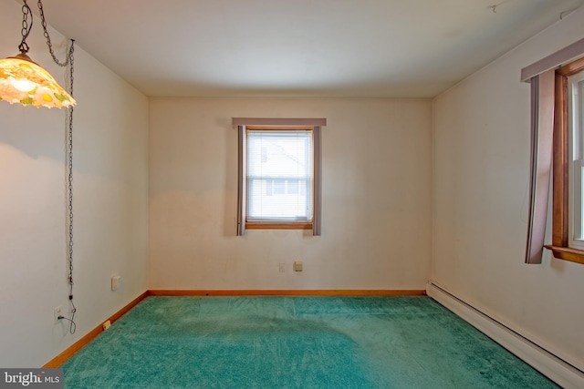 spare room featuring carpet and baseboard heating