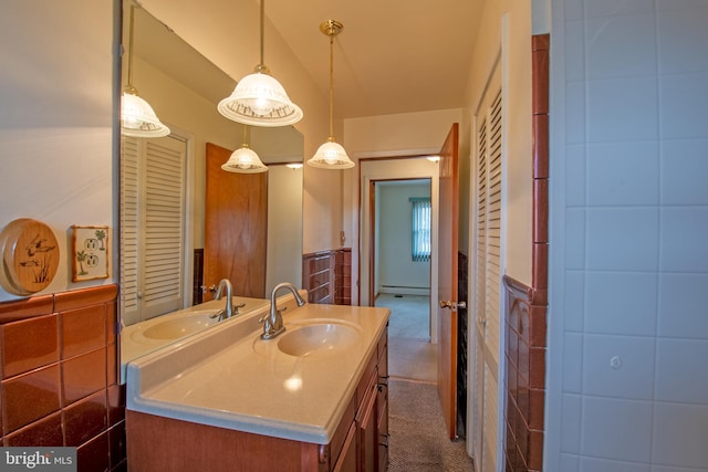 bathroom featuring vanity and tile walls