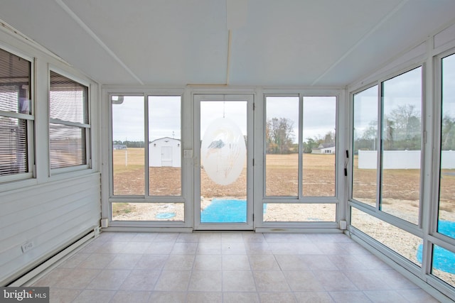 unfurnished sunroom featuring a baseboard heating unit