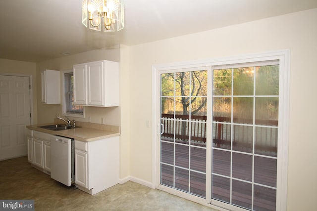 kitchen with sink, white dishwasher, a chandelier, light carpet, and white cabinets