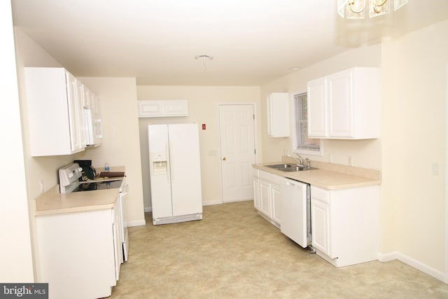 kitchen featuring white cabinets, white appliances, sink, and an inviting chandelier