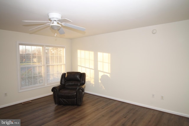 sitting room with dark hardwood / wood-style floors and ceiling fan