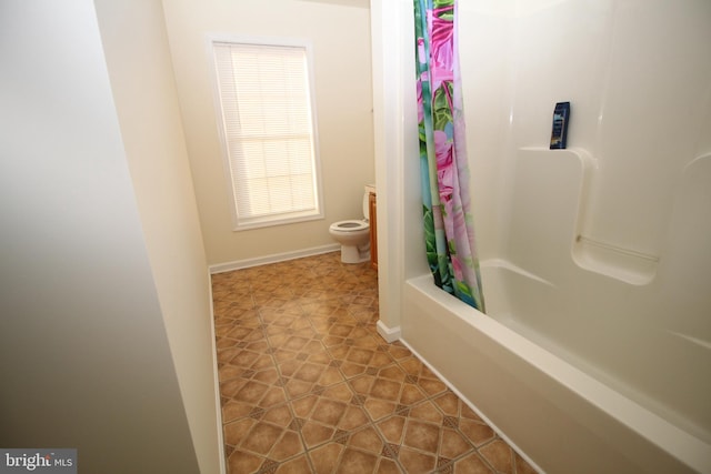 bathroom with tile patterned floors, shower / tub combo, and toilet