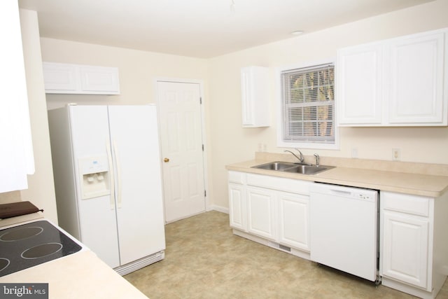 kitchen featuring white cabinetry, sink, and white appliances