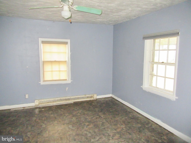 spare room featuring ceiling fan, a textured ceiling, and a baseboard radiator