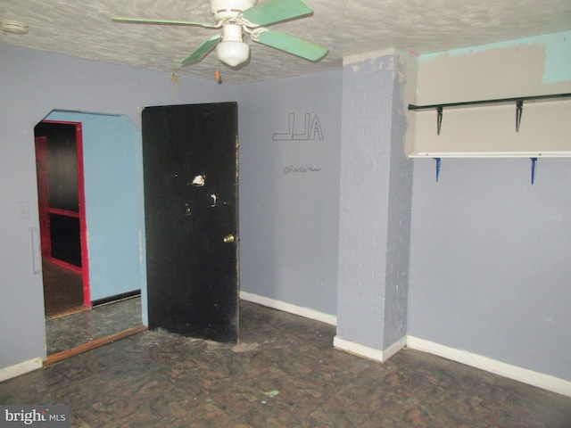 spare room with a textured ceiling and ceiling fan