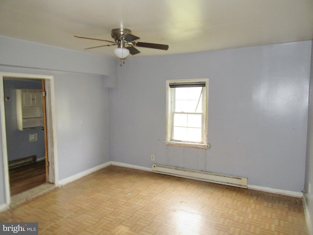 empty room featuring light parquet floors, ceiling fan, and a baseboard heating unit