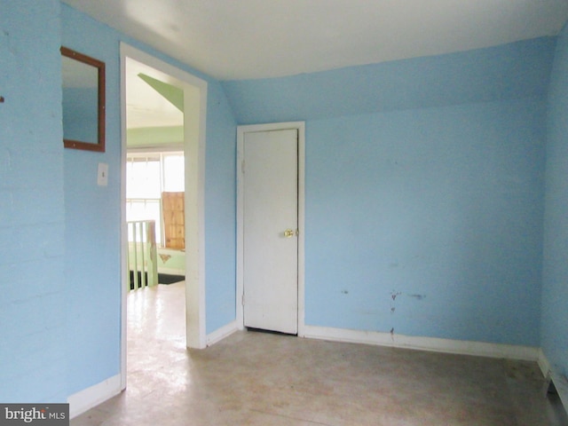 spare room featuring vaulted ceiling