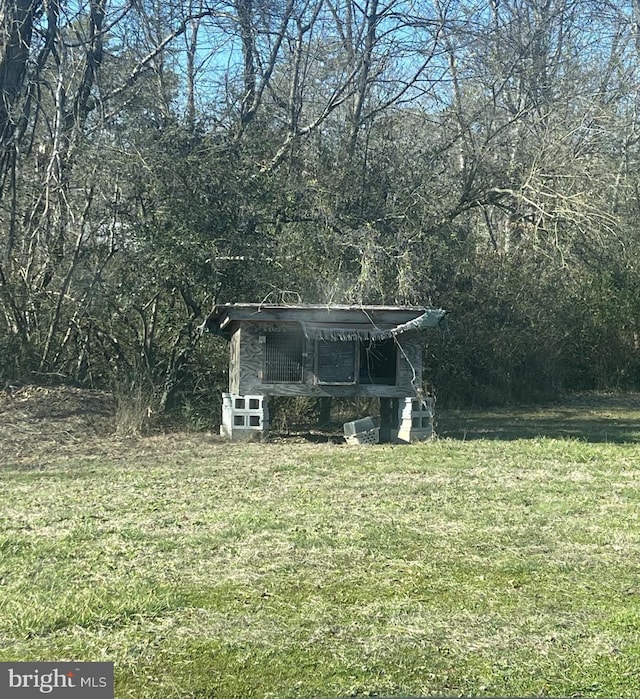 8240 Greenleek Hill Rd, Nanjemoy, MD 20662 - view of grassy yard featuring exterior structure, an outdoor structure, and a forest view