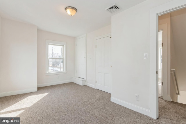 unfurnished bedroom with light colored carpet