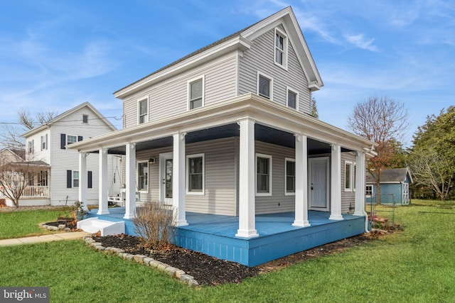 view of front of property with a porch and a front lawn