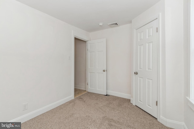 unfurnished bedroom featuring light carpet