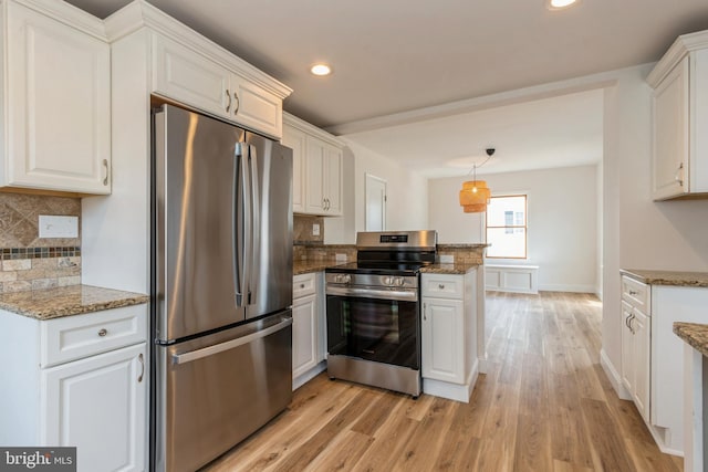 kitchen with stone counters, appliances with stainless steel finishes, light wood-type flooring, and white cabinetry