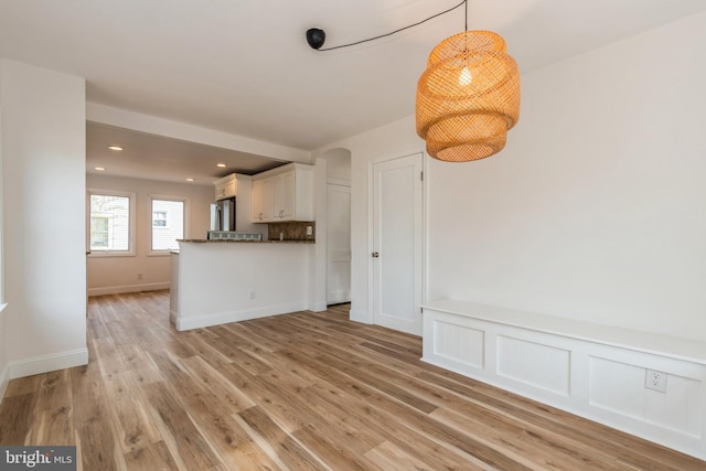 unfurnished living room featuring light hardwood / wood-style flooring