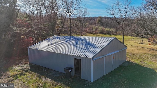 view of outbuilding featuring a lawn