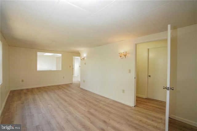 empty room with light hardwood / wood-style flooring