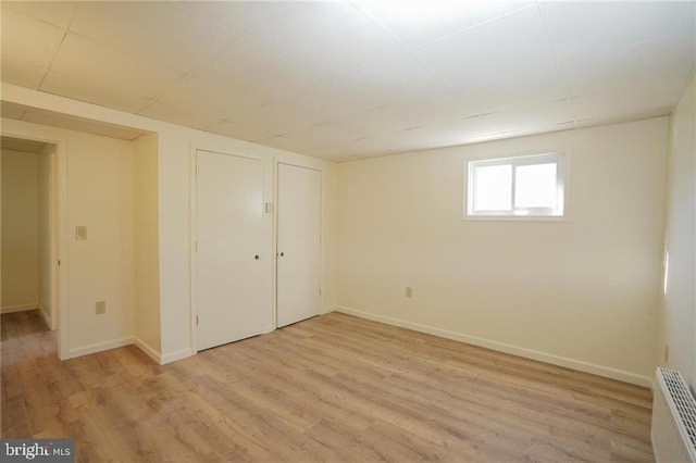 basement with light hardwood / wood-style floors