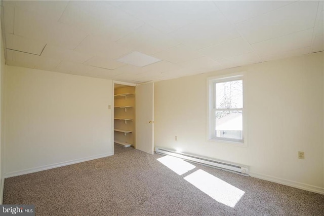 unfurnished room featuring carpet floors and a baseboard radiator