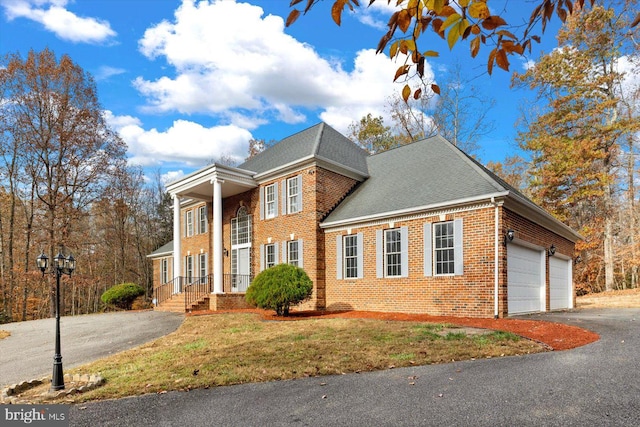 view of front of house featuring a garage and a front yard