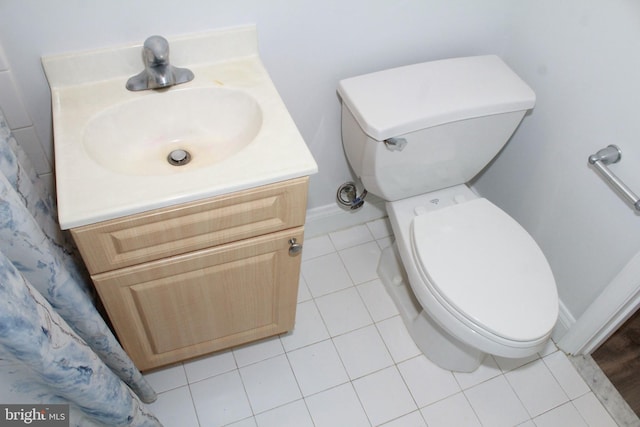 bathroom featuring tile patterned flooring, vanity, and toilet