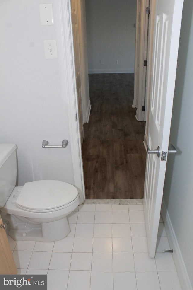 bathroom featuring wood-type flooring and toilet