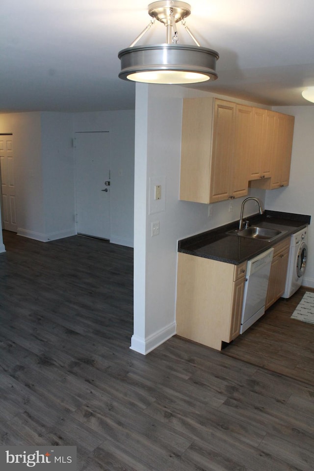 kitchen featuring dishwasher, sink, dark hardwood / wood-style flooring, washer / clothes dryer, and light brown cabinetry