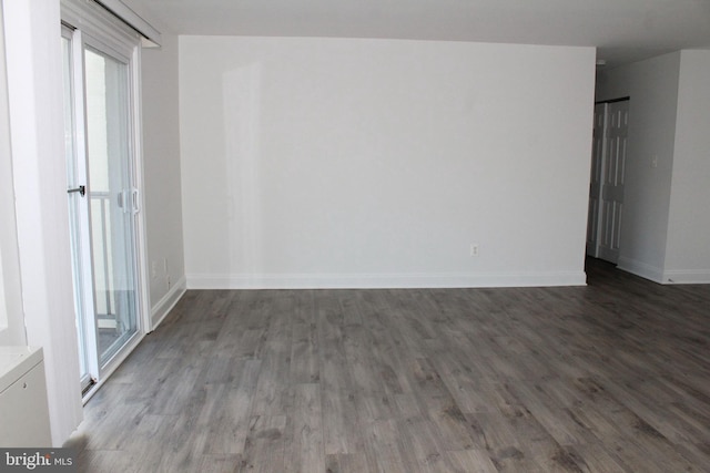 spare room with dark hardwood / wood-style floors