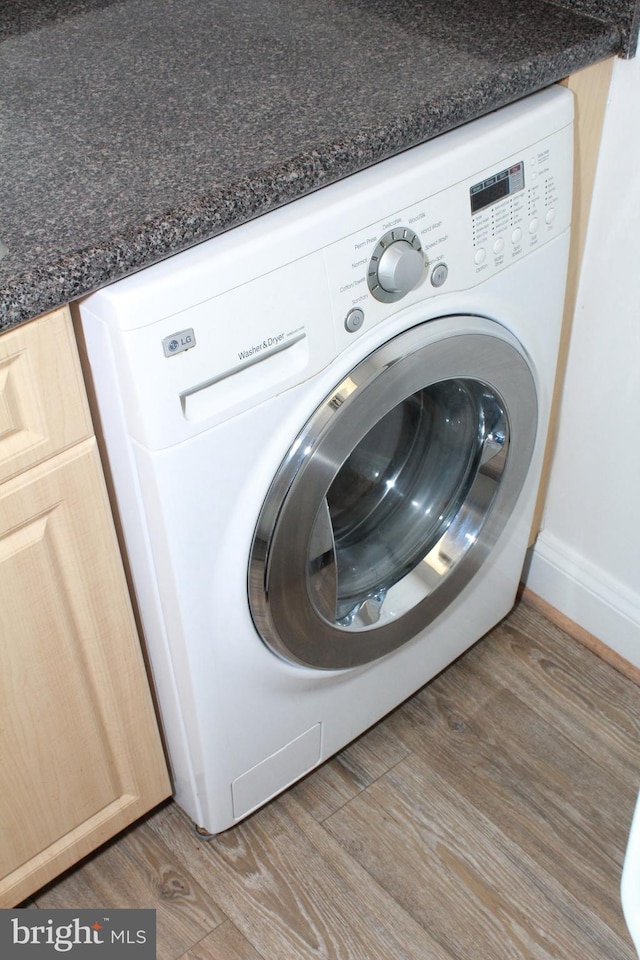 laundry area featuring hardwood / wood-style floors and washer / clothes dryer