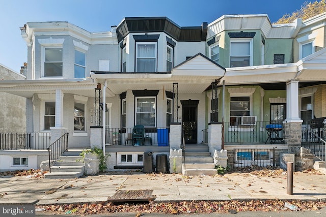 townhome / multi-family property with a porch