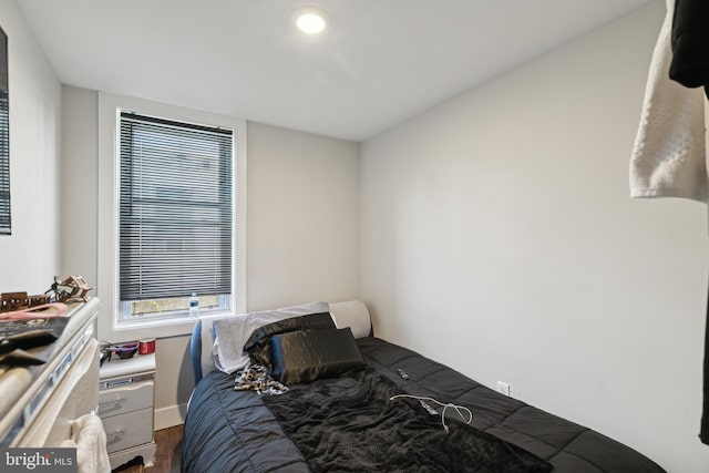 bedroom with hardwood / wood-style flooring