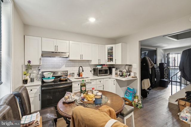 kitchen with white cabinets, dark hardwood / wood-style flooring, sink, and black range with electric cooktop