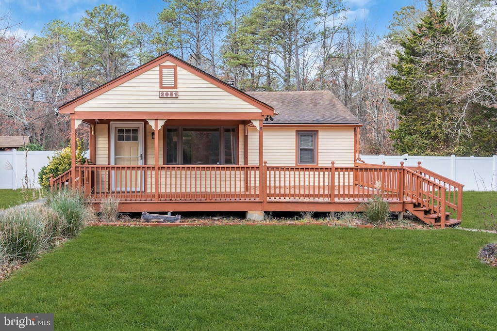 rear view of property with a yard