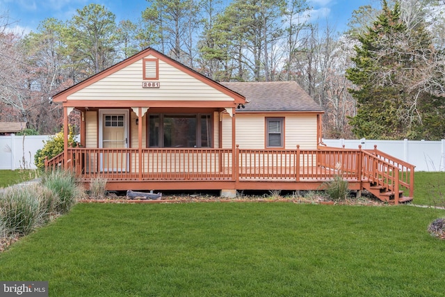 rear view of property with a yard