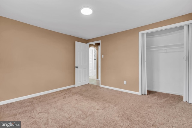 unfurnished bedroom featuring a closet and carpet floors