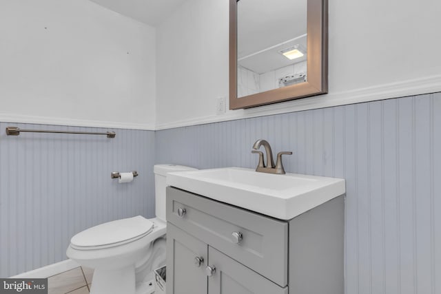 bathroom featuring tile patterned flooring, vanity, and toilet