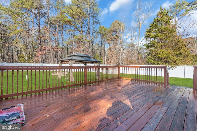 wooden terrace with a gazebo and a yard