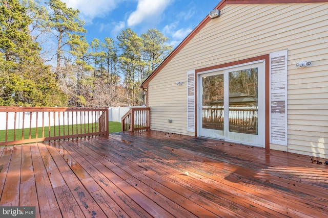 wooden terrace featuring a lawn