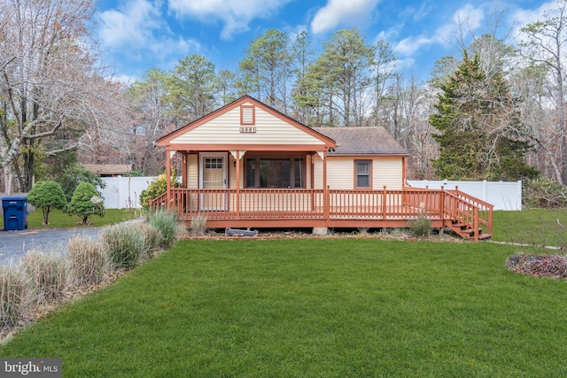 back of property featuring a yard and a deck