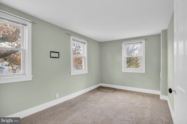 carpeted empty room with plenty of natural light