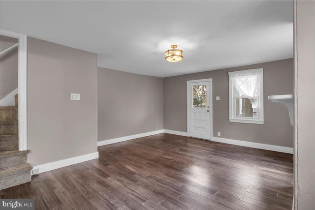 entryway with dark hardwood / wood-style flooring