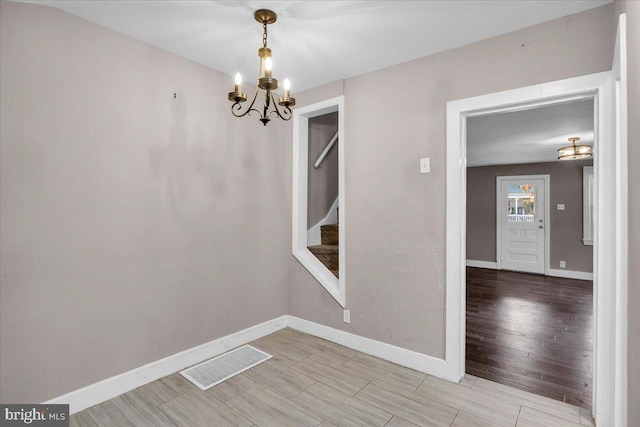 empty room with a notable chandelier