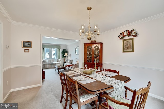 carpeted dining room with crown molding and an inviting chandelier