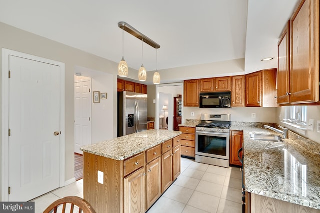 kitchen with a center island, stainless steel appliances, light stone counters, and hanging light fixtures