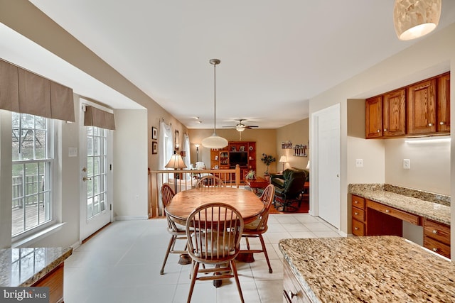 tiled dining space featuring ceiling fan