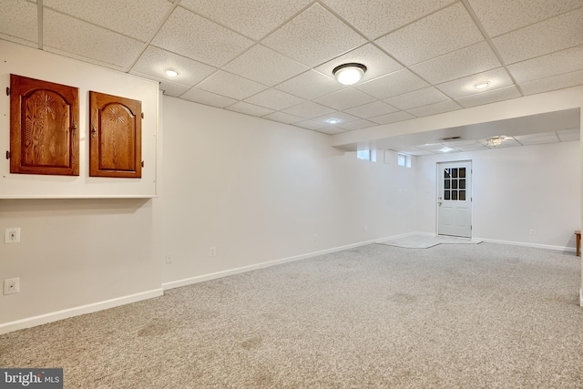 basement featuring carpet flooring and a drop ceiling