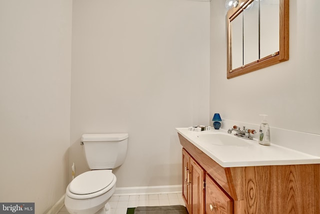 bathroom with tile patterned flooring, vanity, and toilet