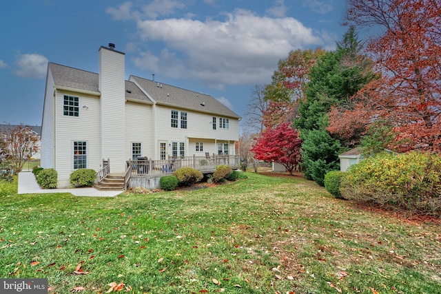 back of house with a lawn and a deck