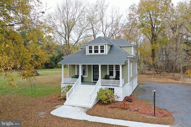 bungalow-style house featuring a porch and a front yard