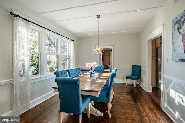 dining area featuring a wealth of natural light, dark wood-type flooring, and a notable chandelier